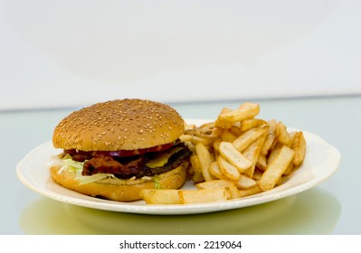 Bacon Cheeseburger With French Fries On A Plate