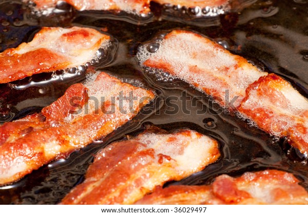bacon-cooking-detail-slices-fat-600w-36029497.jpg