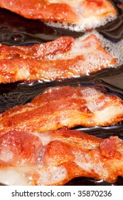 Bacon Detail Frying In A Frying Pan With Grease