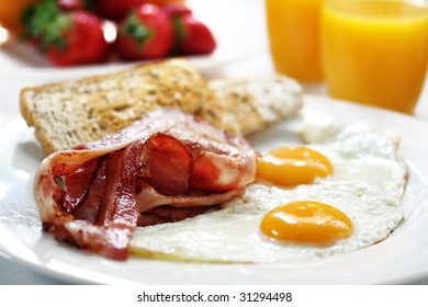 Bacon And Eggs With Toast, Orange Juice And Fresh Fruit.  Shallow DOF.