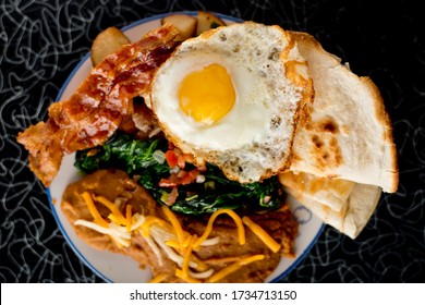 Bacon, Sausage, Fried Eggs, Potato Hash, Refried Beans And Homemade Corn Tortillas. Classic American Diner Breakfast Or Brunch Favorite.