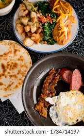 Bacon, Sausage, Fried Eggs, Potato Hash, Refried Beans And Homemade Corn Tortillas. Classic American Diner Breakfast Or Brunch Favorite.