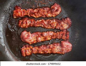 Bacon Slice Being Cooked In Frying Pan. Close Up.