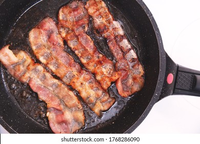 Bacon Strips Or Rashers Being Cooked In Frying Pan. Hearty High-calorie Breakfast. Fast Food, Unhealthy Food.