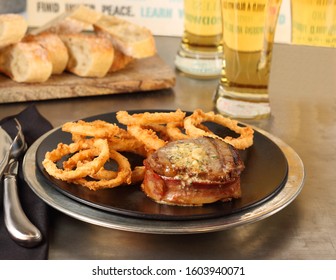 Bacon Wrapped Fillet Mignon With Onion Rings.