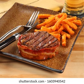 Bacon Wrapped Fillet Mignon With Sweet Potato Fries.