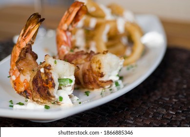 Bacon wrapped shrimp. Jumbo grilled shrimp wrapped in crispy maple smoked bacon and sautéed in butter and garlic. Classic fine dining restaurant appetizer. - Powered by Shutterstock