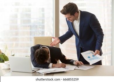 Bad Angry Boss Yelling At Male Sad Depressed Employee, Lying With Face Down On Office Desk, Ineffective Worker Made Mistake Receiving Reprimand From Team Leader, Scolding For Failure, Missed Deadline 