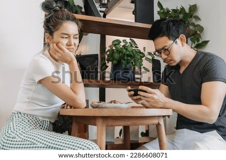 Bad asian couple date of man addicted to mobile game and woman gets mad.