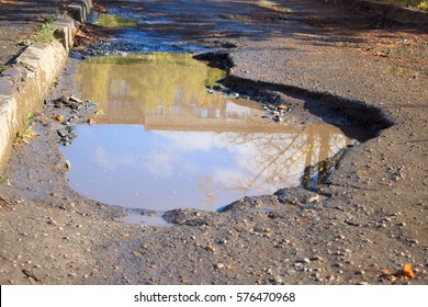 The Bad Asphalted Road With A Big Pothole.