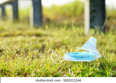 Bad attitute after using face mask during pandemic corona virus. Face mask discarded on the ground