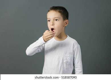 Bad breath. Halitosis concept. Child checking his breath with his hand. - Powered by Shutterstock