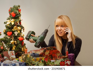 Bad Christmas gift makes the pretty girl look disappointed in x-mas time under the christmas tree. - Powered by Shutterstock