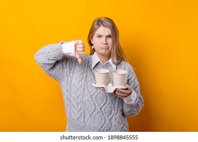 Bad Coffee. Young Woman Showing Thumb Down And Holding Cups Of Coffee, Bad Taste