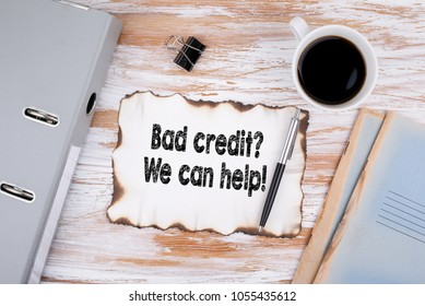 Bad credit, We can help. Business concept. Wooden desk with stationery and a cup of coffee