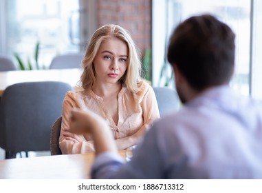 Bad Date. Young Woman Feeling Bored During Dinner At Cafe, Unhappy With Her Boyfriend, Disinterested In Conversation. Stressed Couple Having Difficulties In Relationship, Arguing In Coffee Shop