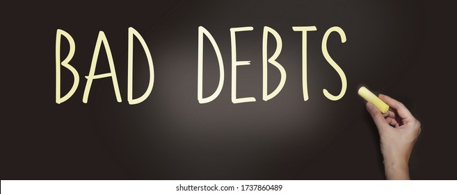 Bad Debts Words Phrase With Chalk On Blackboard. Financial Liabilities Bankruptcy Debt Crisis Concept.