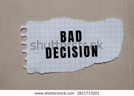 Bad decision message written on crumpled grid paper, illustrating concepts of wrong choice, mistake, and regret