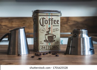 BAD DRIBURG, GERMANY - Feb 22, 2020: A coffee canister surrounded by a Bialetti and some coffee beans