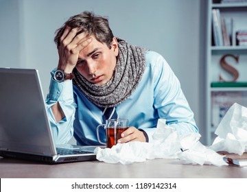 Bad feeling. Sick worker has high temperature. Photo of young man in office suffering virus of flu. Medical concept. - Shutterstock ID 1189142314