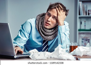 Bad feeling. Sick worker has high temperature. Photo of young man in office suffering virus of flu. Medical concept. - Shutterstock ID 1189142338