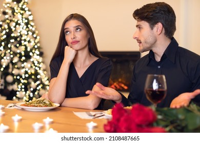 Bad First Impression Concept. Bored Unhappy Girlfriend Listening To Her Talking Boyfriend, Ignoring Man Looking Away And Thinking, Young Couple Sitting At Table, Having Problem In Relationships