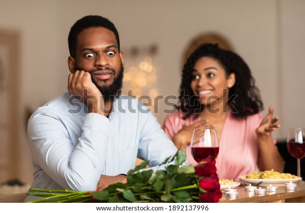 Bad\
First Impression And Date Concept. Dissatisfied shocked black man\
listening to excited emotional obsessed woman talking, young couple\
sitting at table in cafe. Unpleasant\
conversation