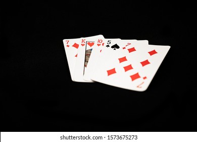 Bad Four Suited Poker Hand On Black Background