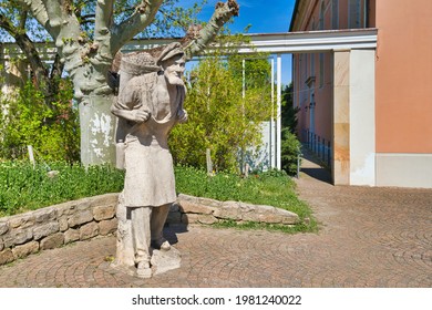 Bad Dürkheim, Germany - April 2021: Sculpture Of A Winegrower With Basket Full Of Grapes By Werner Bernd 