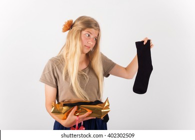 Bad Gift Concept - Beautiful Girl Not Happy With Her Present She Got: A Pair Of Socks..