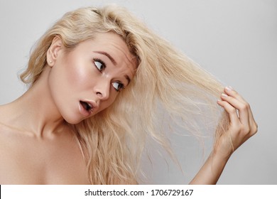 Bad Hair Day. Beautiful Woman With Messed Up Hair. Unhappy Grimacing Face. Blond Bleaching Hairstyle With Problem Brittle Hair