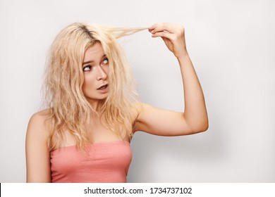 Bad Hair Day. Beautiful Woman With Messed Up Hair. Unhappy Grimacing Face. Blond Bleaching Hairstyle With Problem Brittle Hair