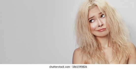 Bad Hair Day. Beautiful Woman With Messed Up Hair. Unhappy Grimacing Face. Blond Bleaching Hairstyle With Problem Brittle Hair