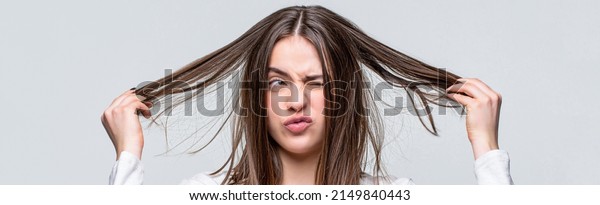 Bad hairs\
day. Frustrated woman having a bad hair. Woman having a bad hair,\
her hair is messy and tangled. Messy hair. Brunette woman with\
messed hairs. Girl having a bad\
hairs.