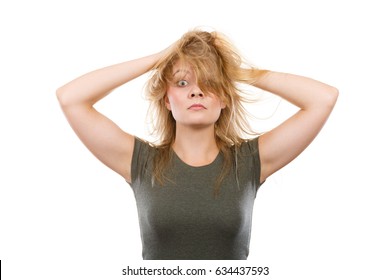 Bad Hairstyle Concept. Crazy, Mad Blonde Woman With Messy Hair Looking Stressed Out. Studio Shot On White Background.