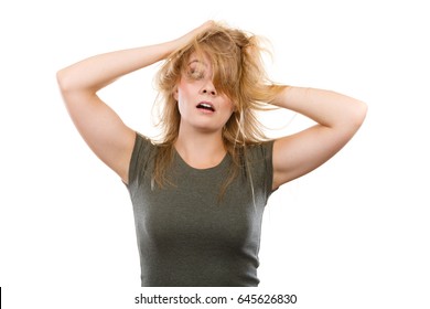 Bad Hairstyle Concept. Crazy, Mad Blonde Woman With Messy Hair Looking Stressed Out. Studio Shot On White Background.