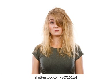 Bad Hairstyle Concept. Sad Blonde Woman With Messy Hair Looking Tired And Dissatisfied. Studio Shot On White Background.