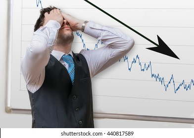 Bad investment or economic crisis concept. Businessman is disappointed from losing in stock exchange. Chart with arrow down on whiteboard in background.