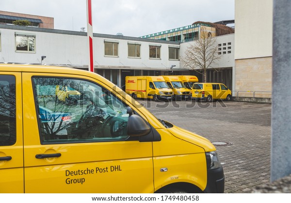 Bad\
Kissingen/Germany-31/12/18: Deutsche Post DHL Group auto fleet on a\
car parking near Post Office on Münchner Street. Deutsche Post DHL\
Group is the world\'s largest courier\
company