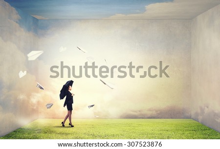 Bad luck and crisis concept with young businesswoman with black umbrella 