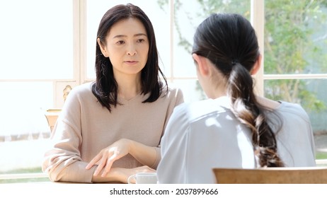 Bad Mood Asian Mother Talking To Daughter