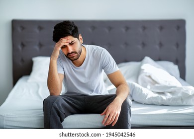 Bad Mood In Morning. Depressed Arab Guy Sitting On Bed And Contemplating About Problems, Copy Space. Stress, Apathy, Male Depression And Mental Health Issue Concept.