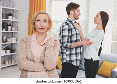 Bad Mood. Unhappy Aged Woman Standing In The Living Room While Thinking About Her Daughters Husband