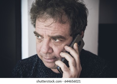 Bad News. Sad Adult Man Talking On Phone.