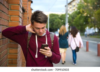 Bad News. Teen Boy Reads Sms On Smartphone