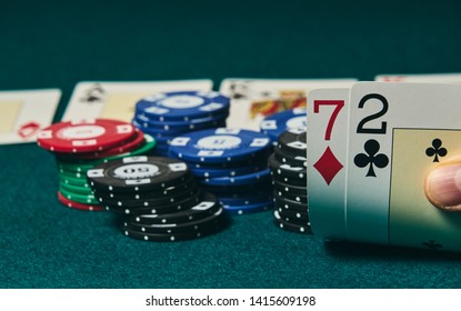 Bad poker gamble or unlucky hand concept with player going all in with 2 and 7 (two and seven) offsuit also called unsuited, considered the worst hand in poker preflop (before the flop is revealed) - Shutterstock ID 1415609198