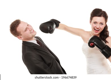 Bad Relationship- Conflict. Funny Married Couple Fighting. Wife Showing Her Husband Who's Boss. Angry Woman Bride In Wedding Dress Boxing Punching Man Groom Isolated On White