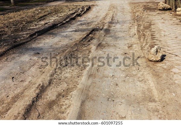 Bad road, damaged by rain and snow, needs repair.\
Broken asphalt coating leads to pothole, dangerous for vehicles and\
pedestrians. Bad emergency road. Dangerous road.  Destruction\
roads, large cracks