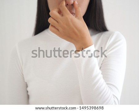 bad smell in nose in asian woman and cause of nasal polyps or sinus infection and post nasal drip on white background use for health care concept.