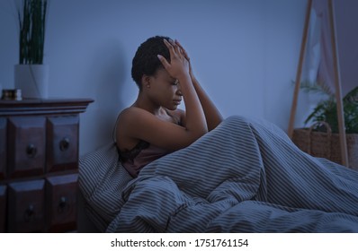 Bad Thoughts And Dreams. Upset African American Girl Press Hands To Head And Cannot Sleep, At Night, In Bed, In Interior